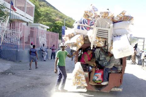 A Haitian merchant takes his goods to the Dominican Republic on a road by Lake Azuei February 5,...